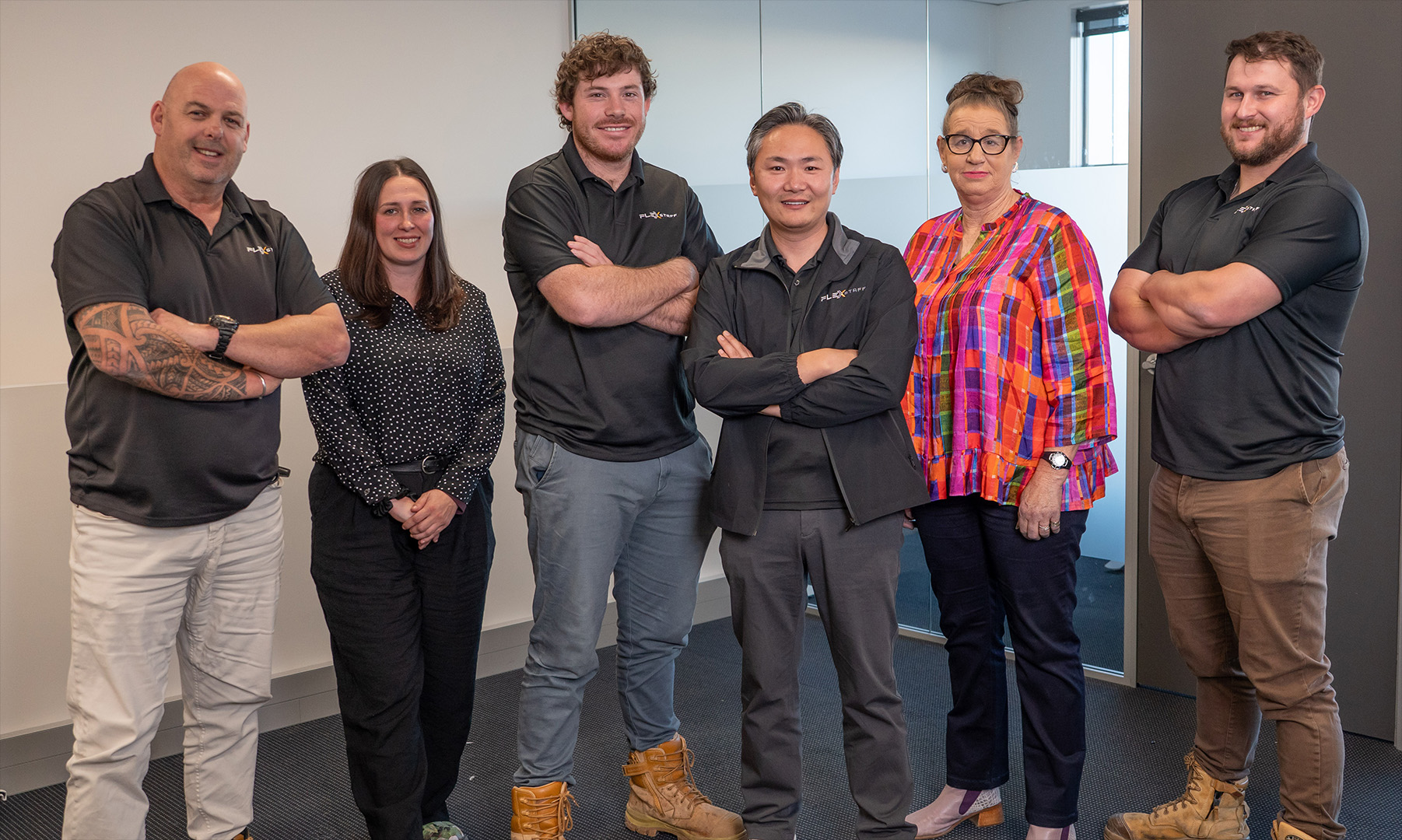 The Flexstaff team standing together in their office