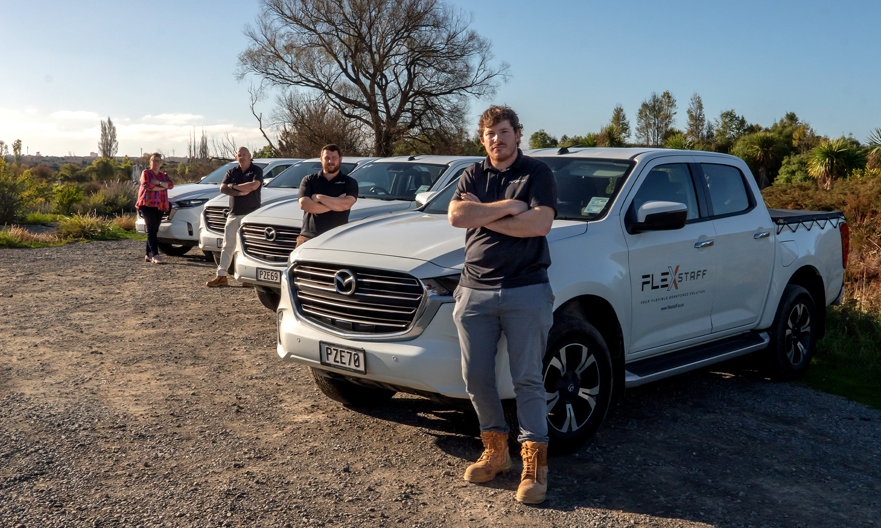 Flexstaff team members beside company vehicles